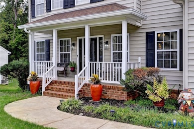 Doorway to property with covered porch and roof with shingles