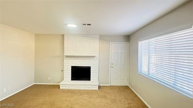 Unfurnished living room featuring carpet flooring and a fireplace