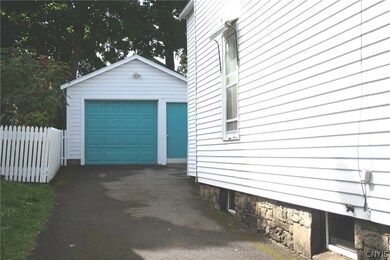paved driveway to a one car garage or workshop