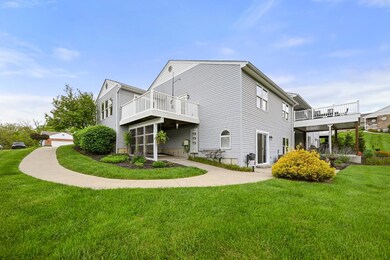 Gently sloping concrete path leads around the cond