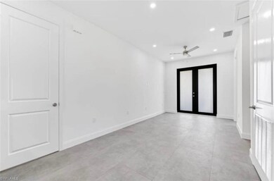 Empty room with recessed lighting, a ceiling fan, and french doors