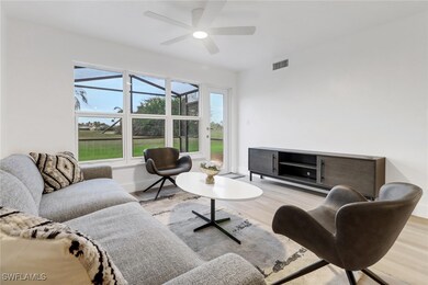 Living room featuring light wood-style floors, bas
