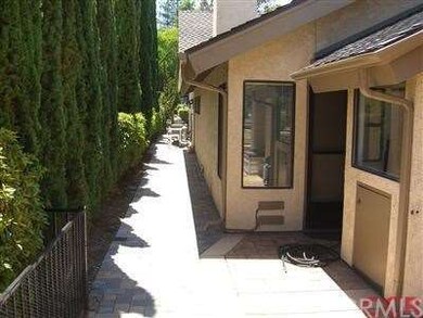 Side yard with concrete pavers.