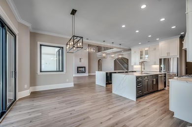 Kitchen featuring a center island with sink, crown