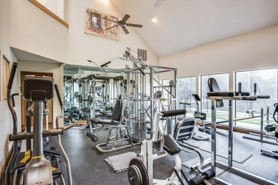 Gym featuring high vaulted ceiling, a ceiling fan, and recessed lighting