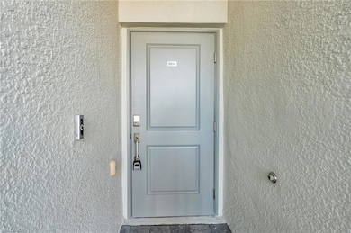 Entrance to property with stucco siding