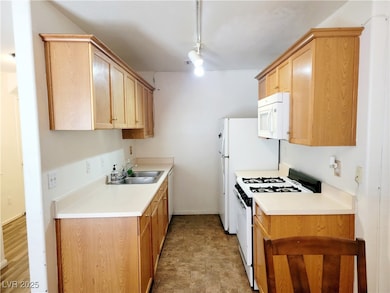 Kitchen featuring and white appliances