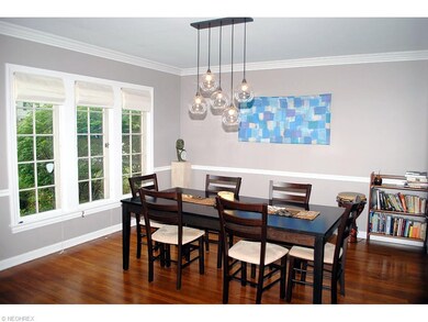 SPACIOUS DINING ROOM HAS AN UPDATED CHANDELIER