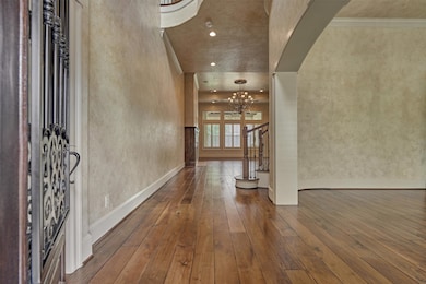 This spacious entry hallway features elegant wood