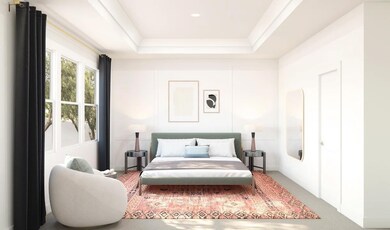 Primary suite with tray ceiling and decorative feature wall