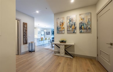 Corridor featuring wood finished floors, baseboard