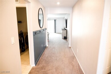 Corridor featuring baseboards and light carpet