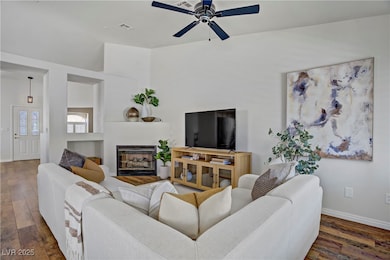 Living area with wood-type flooring, a ceiling fan