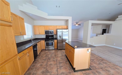 Kitchen featuring stainless steel appliances, a si