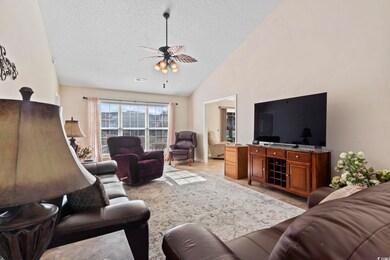 Living room with a textured ceiling, ceiling fan, 
