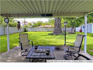 Large covered patio overlooking fully fenced yard.