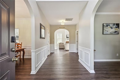 Entrance foyer featuring dark wood-type flooring