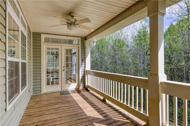 Wooden terrace with ceiling fan and french doors