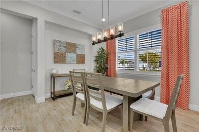 Dining room with an inviting chandelier, crown mol