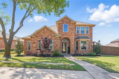 Traditional home featuring a front yard, brick sid