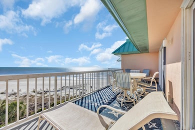 Balcony with a water view and a view of the beach