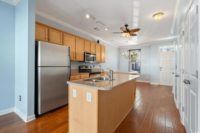 Kitchen featuring ornamental molding, a center isl