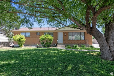 Ranch-style home with brick siding, a front yard, and entry steps