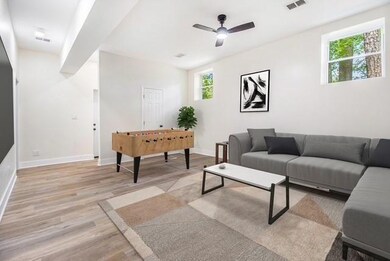 Living area featuring a ceiling fan, baseboards, visible vents, and light wood-type flooring