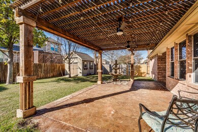 Beautiful expended covered patio with stamped stained concrete, shed, mature trees and pletny of room t