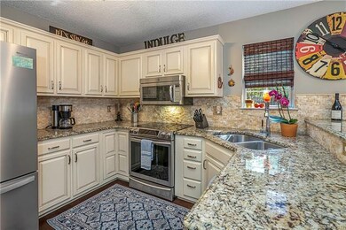 Upgraded kitchen quartz backsplash and granite cou