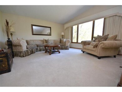 Vaulted upper level living room features a large p
