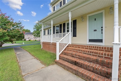 Entrance to property with a porch and a yard