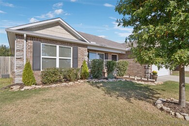 Stone and brick elevation with gutters and professional landscaping.