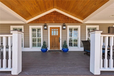 View of exterior entry featuring covered porch