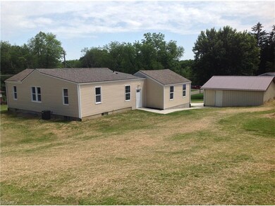 back view with large mostly fenced in yard and bac