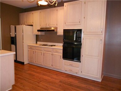 The kitchen has plenty of cabinets, double ovens a