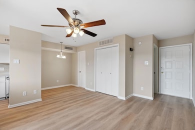 Unfurnished living room featuring ceiling fan, li