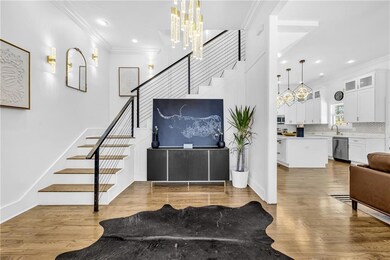 Foyer entrance featuring ornamental molding, stairway, a chandelier, wood finished floors, and recessed lighting