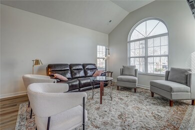 Living area with visible vents, baseboards, high v