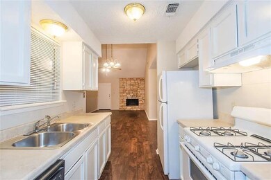 Kitchen featuring white gas stove, a sink, under 