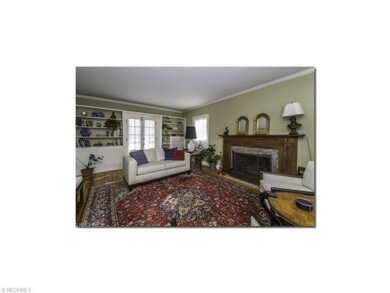 Spacious living room with marble trimmed fireplace