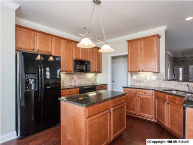 Imagine the delicious meals that can be made from this gorgeous open kitchen with island, granite counters, breakfast bar, under cabinet lighting and lots of cabinet space!