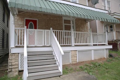 Spacious front porch with safety gate.