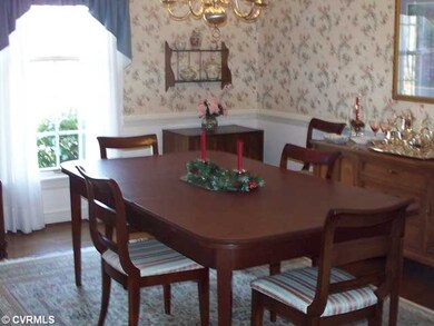 Dining Room - Hardwood floor with chairrail and cr