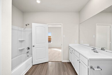 The primary bathroom has tons of room with a walk-