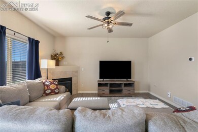 Living room with ceiling fan, light hardwood / woo