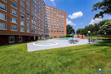 View of home's community with a pool, a lawn, and a patio area