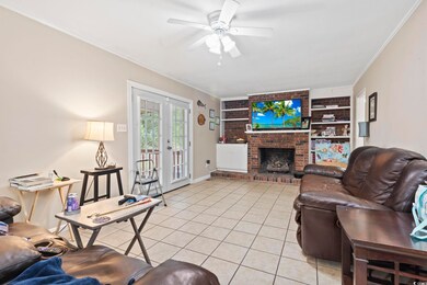 Living room featuring ceiling fan, french doors, a