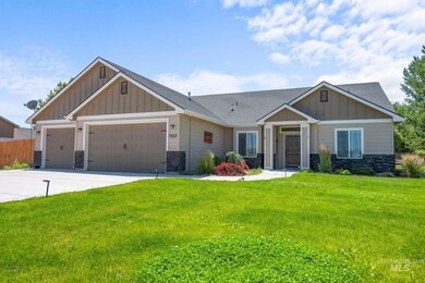 Craftsman inspired home with board and batten siding, stone siding, a garage, and a shingled roof