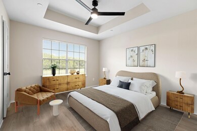 Bedroom with baseboards, a ceiling fan, a tray ce